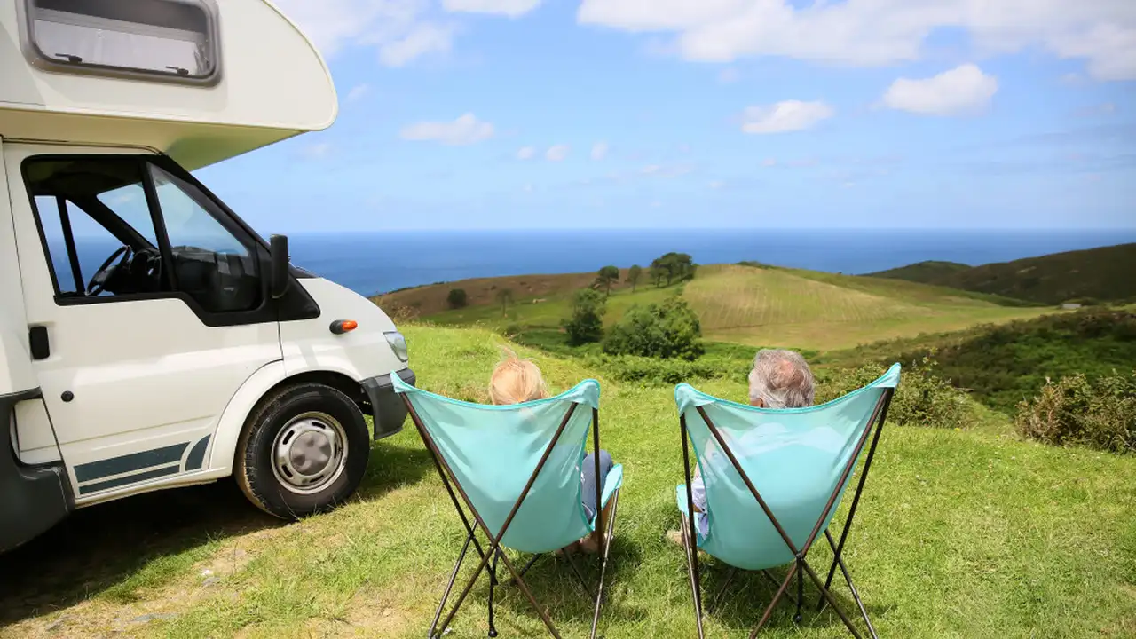 overhead view of corned beef sliced and on a platter with cabbage, potatoes, and carrots