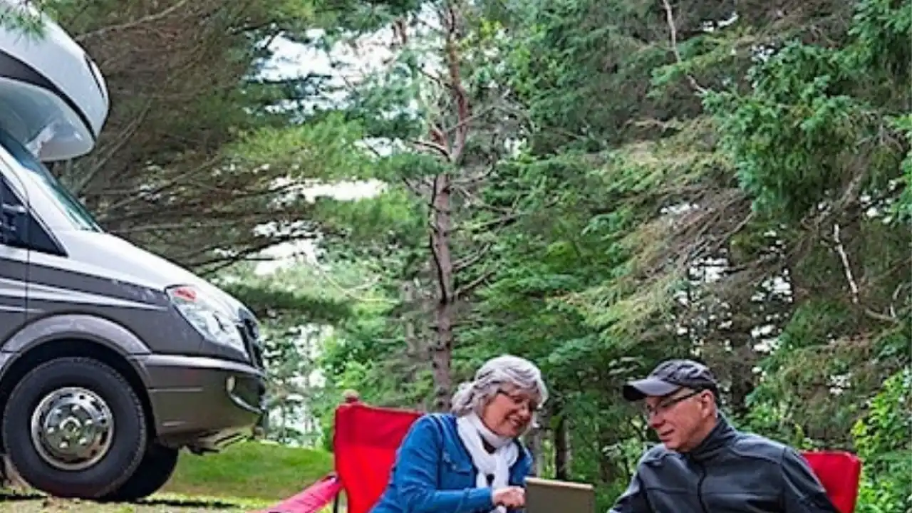 Close up on a plate of mashed potatoes, topped with baked pork chops with cream of mushroom soup, and a side of green beans.