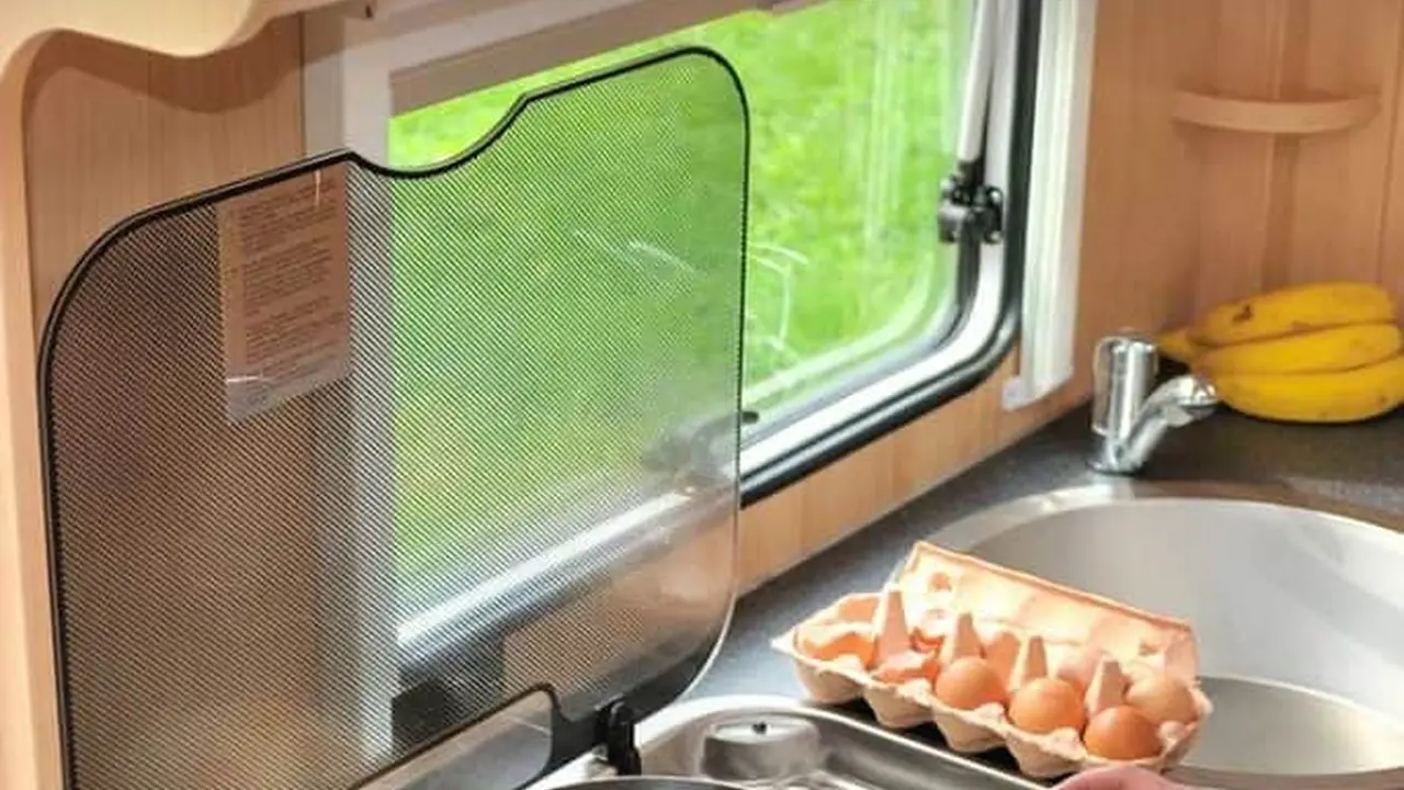 Two mint chocolate milkshakes with whipped cream and green sprinkles.